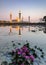 Reflection of Bukit Jelutong Mosque with purple lotus in the lake