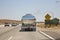 Reflection of a car in a chrome truck transporting liquids