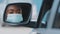 Reflection in car mirror beautiful young african american woman driver black mixed race girl with stylish makeup wears