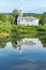 Reflection of church and building on water