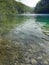Reflection clear water of Plitvice lakes national park UNESCO, dramatic unusual scenic, green foliage alpine forest, biological