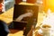 Reflection of the girl`s face in the laptop screen, girl covers her mouth, looking at the phone in his hand. Cafe