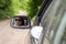 Reflection of a girl sitting in the car in a car mirror