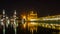 Reflection of golden temple at night on water surface of nearby lake