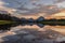 Reflection of Grand Tetons in Jackson Lake at sunset