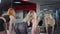 Reflection in gym mirror of two confident fit motivated sportswomen lifting weights. Slim Caucasian blond and redhead