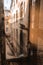 Reflection of a hand in a window looking in courtyard