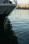 Reflection of the hull of a sailing yacht boat anchored in the port of toulon, on the blue seas of the mediterranean, during a sun