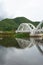 Reflection image of The Tha Chomphu Railway Bridge or White Bridge