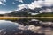 Reflection with lake and mountains low hanging couds in Lower Kananaskis Lake of Peter Lougheed Provincial Park