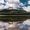 Reflection with lake and mountains low hanging couds in Lower Kananaskis Lake of Peter Lougheed Provincial Park