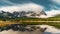 Reflection with lake and mountains low hanging couds in Lower Kananaskis Lake of Peter Lougheed Provincial Park