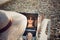 Reflection in the laptop monitor of a young, smiling girl with glasses and hat, freelancer on the coast