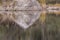 Reflection of large boulder in the shape of a triangle