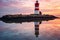 reflection of a lighthouse in calm waters at twilight