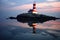 reflection of a lighthouse in calm waters at twilight