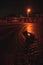 Reflection of the lighthouse in the puddle in the dark afternoon hours, England 2022 January