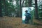 Reflection of male tourist with backpack in mirror, standing in pine forest. Hiking, trekking, staycation, active outdoor