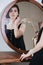 Reflection in a mirror of a cute sensual young woman in a black dress.