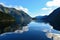 Reflection of mountains along the fiord of Doubtful Sound in Fiordland National Park in New Zealand
