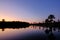 Reflection of the palm trees in the lagoon Lagoa das Araras at sunrise, Bom Jardim, Mato Grosso, Brazil, South America