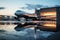 Reflection of a passenger aircraft near the jetway captured in a puddle