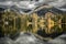 Reflection of peaks on water surface of tarn Strbske pleso in High Tatras mountain at Slovakia