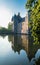 Reflection in the pond of the turrets of the 14th century Chateau de Trecesson
