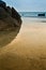 Reflection of Rock on beach