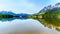 Reflection of the Rocky Mountains range on the smooth water surface of Yellowhead Lake in Robson Provincial Park