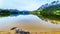 Reflection of the Rocky Mountains range on the smooth water surface of Yellowhead Lake in Robson Provincial Park