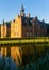 Reflection of Rumbeke Castle in water on summer day located in Rumbeke, Belgium