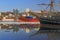 Reflection sailing ship and buildings of the city of Vladivostok in winter sea surface