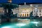 Reflection of sign of National Theatre at illuminated fountain at Rossio Square in Lisbon