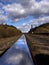 Reflection of sky with clouds in polished rail