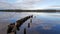 Reflection of the sky and clouds in the waters of the lake breakwater breaking the waves access port harbor Biscarrosse France