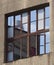 Reflection of Sky and Industrial Tower in Window