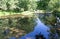 Reflection of sky on Sandy River in Unity Maine in the summertime