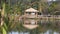 Reflection of A Small Hut On A Beautiful Lake With Leaves - Close up