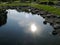 Reflection of the sun in the pond,  stones, Helsinki, Finland