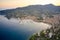 Reflection of sun rays in the water Ligurian sea at the sunset. Panorama of harbor with moored white yachts and boats in