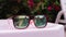 Reflection in sunglasses of teenagers girl enjoy in hotel swiming pool in vacation. two sisters playing, swimming and
