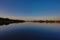 Reflection of the surrounding vegetation in a mesmerizing mirror lake captured in twilight