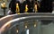 Reflection of three candles in the water standing on the edge of the font in the Orthodox Church.