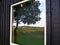 Reflection of a tree and country side on the window