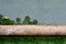 The reflection of tree in the flooding water surface on the artificial grass football field