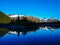 Reflection of Trees, Mountains, and Sky in a Mountain Lake