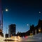 Reflection of urban buildings in a puddle of rain water at night