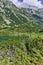 Reflection of Vihren peak in Okoto lake, Pirin Mountain