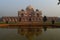 A reflection in water and mesmerizing view of humayun tomb memorial from the main gate,entrance at winter foggy morning